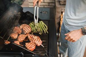 Cooking meat and vegetables on an outdoor grill photo