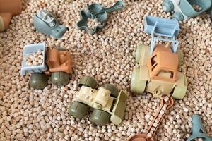 A modern children's sandbox with toys. Sandbox filler in the form of wooden small wooden cubes photo