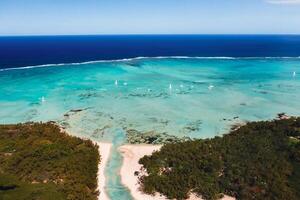 Aerial picture of the east coast of Mauritius Island. Beautiful lagoon of Mauritius Island shot from above. Boat sailing in turquoise lagoon photo