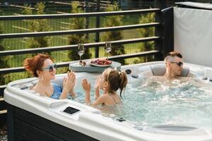 In summer, the family rests in the outdoor hot tub photo