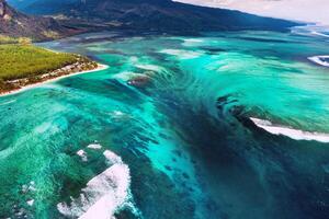 The view from the bird's eye view of the coral reef near the mountain Le Morne Brabant, a beautiful blue lagoon and the underwater waterfall photo