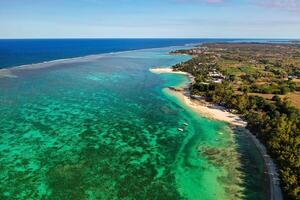 View from the height of the east coast of the island of Mauritius. Flying over the turquoise lagoon of the island of Mauritius in the area of Bel Mare. photo