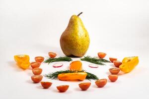 The face of a man made of sliced vegetables and a pear on his head on a white background photo