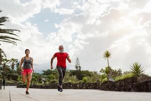 Couple doing running training session outdoor - Sporty people workout sprint exercises - Health activity and lifestyle sport concept photo