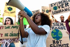 Group of activists protesting for climate change during covid19 - Multiracial people fighting on road holding banners on environments disasters - Global warming concept photo
