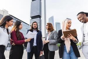 Multiracial business people having a briefing outside the office photo