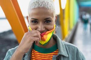 Young woman wearing gay pride mask symbol of Lgbtq social movement photo