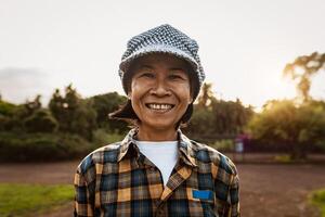 Happy Southeast Asian woman having fun smiling on camera in a public park photo