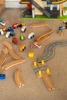 A scattered wooden road construction kit on the floor. Child's play photo