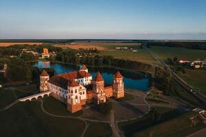Mir castle with spires near the lake top view in Belarus near the city of Mir photo