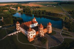 Mir castle with spires near the lake top view in Belarus near the city of Mir photo