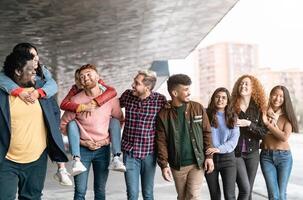 Young multiracial friends having fun together hanging out in the city - Friendship and diversity concept photo