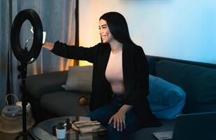 Young woman vlogging online with smartphone cam and ring led from home - Youth people with social media and smart working concept photo