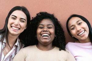 Happy multiracial friends having fun smiling together in front of camera photo