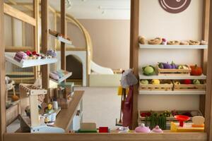 Wooden children's play kitchen with dishes and artificial food photo