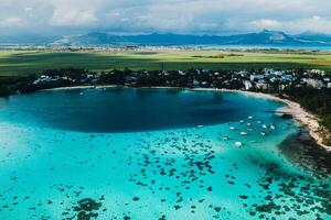 Aerial picture of the east coast of Mauritius Island. Beautiful lagoon of Mauritius Island shot from above. Boat sailing in turquoise lagoon photo