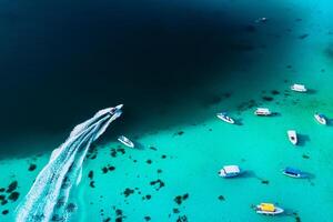 Aerial picture of the east coast of Mauritius Island. Beautiful lagoon of Mauritius Island shot from above. Boat sailing in turquoise lagoon photo