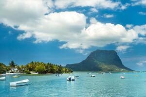 View of the mountain in Le Morne Brabant and the bay with boats on the island of Mauritius in the Indian Ocean photo