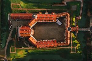 Aerial photo Nesvizh castle in autumn evening, Belarus Minsk, top view