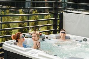 In summer, the family rests in the outdoor hot tub photo