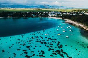 Aerial picture of the east coast of Mauritius Island. Beautiful lagoon of Mauritius Island shot from above. Boat sailing in turquoise lagoon photo