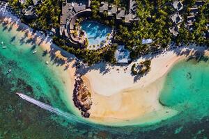 Aerial picture of the east coast of Mauritius Island. Flying above the turquoise lagoon of Mauritius in the region of Belle Mare. photo