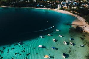Aerial picture of the east coast of Mauritius Island. Beautiful lagoon of Mauritius Island shot from above. Boat sailing in turquoise lagoon photo