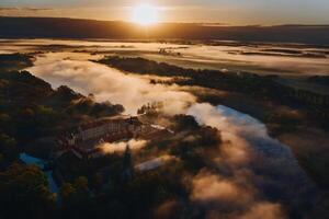 Foggy dawn in Nesvizh.View from the height of the Nesvizh castle and Park at dawn.Misty dawn photo