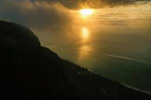 View from the height of the island of Mauritius in the Indian Ocean and the beach of Le Morne-Brabant at sunset photo