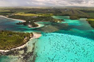 Top view of the Blue Bay lagoon of Mauritius. A boat floats on a turquoise lagoon photo