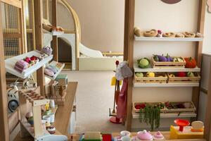 Wooden children's play kitchen with dishes and artificial food photo