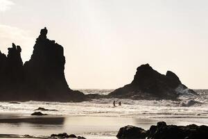 People on the sandy beach of Benijo on the island of Tenerife.Spain photo