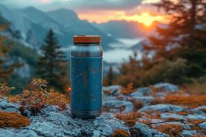 AI generated An outdoor thermos flask stands on a rock at sunset photo