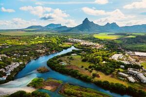 A river flowing into the ocean on the tropical island of Mauritius.Nature on the island of Mauritius, mountains and river of the island of Mauritius photo