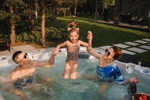 In summer, the family rests in the outdoor hot tub photo