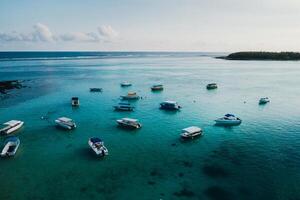 Aerial picture of the east coast of Mauritius Island. Beautiful lagoon of Mauritius Island shot from above. Boat sailing in turquoise lagoon photo