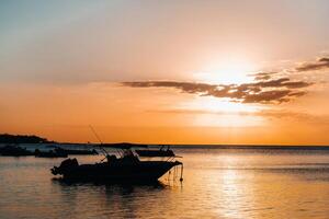 Boat at sunset in the Indian ocean off the coast of Mauritius. photo