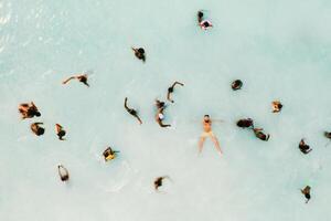 The view from the bird's eye view of the ocean, filled with people on a hot Sunny day.People swim in the Indian ocean on the island of Mauritius photo