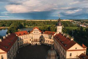 Aerial photo Nesvizh castle in autumn evening, Belarus Minsk, top view