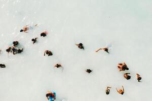 The view from the bird's eye view of the ocean, filled with people on a hot Sunny day.People swim in the Indian ocean on the island of Mauritius photo