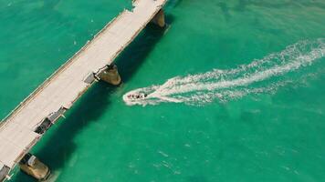 Old Seven Mile Bridge Aerial view Old damaged bridge across the lake top view. A scooter floats under a destroyed bridge. video