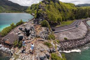 The couple stands on the edge of a cliff on the island of Mauritius.An unusual road to the islands of Mauritius. photo