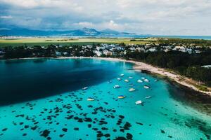 Aerial picture of the east coast of Mauritius Island. Beautiful lagoon of Mauritius Island shot from above. Boat sailing in turquoise lagoon photo