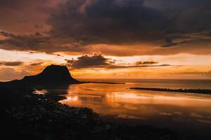 Aerial view with ocean at warm sunset time and Le Morn mountain in Mauritius. photo