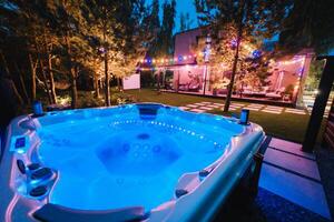 self-contained hot tub or pool with hot water and evening lighting photo