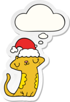 lindo gato de dibujos animados con sombrero de navidad y burbuja de pensamiento como pegatina impresa png