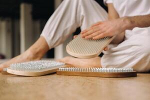 A man holds in his hands boards with nails for yoga classes photo