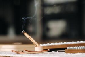 A smoking Palo Santo stick and boards with nails for yoga classes photo