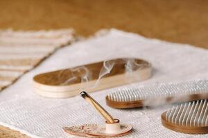 A smoking Palo Santo stick and boards with nails for yoga classes photo