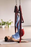 Pregnant girl. A woman does yoga on a hammock in the gym. The concept of a healthy lifestyle, Motherhood photo